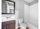 Clean bathroom with dark wood vanity, white sink, toilet, and a bathtub shower at 1235 Renaissance Se Ct, Mableton, GA 30126