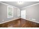 This bedroom boasts hardwood floors, two windows, crown molding, and a closet at 1235 Renaissance Se Ct, Mableton, GA 30126