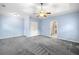 Spacious bedroom featuring tray ceilings, a ceiling fan, and plush gray carpeting at 1235 Renaissance Se Ct, Mableton, GA 30126