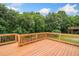 Open backyard deck with wood railings, lush greenery, and scenic views of the surrounding treescape at 1235 Renaissance Se Ct, Mableton, GA 30126