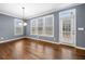 A bright dining room features hardwood floors, large windows, and a door to the deck at 1235 Renaissance Se Ct, Mableton, GA 30126