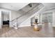 Bright foyer featuring a curved staircase, elegant lighting, and beautiful floors, creating a welcoming entrance at 1235 Renaissance Se Ct, Mableton, GA 30126