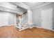 Bright foyer with white staircase, hardwood floors, built-in bench, and exterior door, perfect for welcoming guests at 1235 Renaissance Se Ct, Mableton, GA 30126