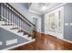 Elegant foyer with hardwood floors, a staircase, and a view of the front entrance at 1235 Renaissance Se Ct, Mableton, GA 30126