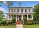 Charming two-story home featuring a welcoming front porch and manicured landscaping at 1235 Renaissance Se Ct, Mableton, GA 30126