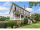 Beautiful home with a covered front porch, lush landscaping, and classic architectural details at 1235 Renaissance Se Ct, Mableton, GA 30126