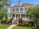 Attractive two-story home with a covered front porch and beautifully landscaped front yard at 1235 Renaissance Se Ct, Mableton, GA 30126