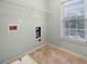 Functional laundry room equipped with connections, shelving, and tile flooring at 1235 Renaissance Se Ct, Mableton, GA 30126