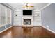 A cozy living room features a fireplace with stone surround and built-in bookshelves at 1235 Renaissance Se Ct, Mableton, GA 30126