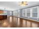 Large open-concept living space with hardwood floors, many windows, and an island at 1235 Renaissance Se Ct, Mableton, GA 30126