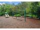 Community playground area with swings, slides, and a merry-go-round surrounded by trees at 1235 Renaissance Se Ct, Mableton, GA 30126