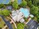 Aerial view of community clubhouse and pool with sundeck, tennis courts, and lush landscaping at 1235 Renaissance Se Ct, Mableton, GA 30126