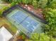 Aerial view of community tennis court and surrounding foliage with play area in the background at 1235 Renaissance Se Ct, Mableton, GA 30126