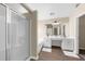 Bright bathroom featuring a glass shower, soaking tub, double vanity, and wood look floors at 3559 Reservoir Pass, Acworth, GA 30101