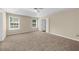 Spacious bedroom featuring neutral walls, carpet floors, a ceiling fan, and natural light from the windows at 3559 Reservoir Pass, Acworth, GA 30101