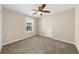 Bright bedroom featuring neutral walls, carpet, a ceiling fan, a window, and a small storage closet at 3559 Reservoir Pass, Acworth, GA 30101