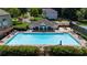 Aerial view of the community pool and clubhouse, complete with lounge chairs and umbrellas at 3559 Reservoir Pass, Acworth, GA 30101