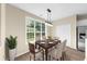 Bright dining area features modern lighting, wood floors, and large windows overlooking the yard at 3559 Reservoir Pass, Acworth, GA 30101