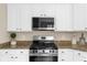 Well-equipped kitchen with white cabinets, granite countertops, and stainless steel appliances at 3559 Reservoir Pass, Acworth, GA 30101