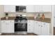 Kitchen features white cabinets, granite countertops, and stainless steel range at 3559 Reservoir Pass, Acworth, GA 30101