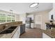 Kitchen features granite counters, stainless appliances, and wood floors at 3559 Reservoir Pass, Acworth, GA 30101