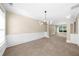 Bright living room with neutral carpet, paneled wainscoting, and modern chandelier at 3559 Reservoir Pass, Acworth, GA 30101