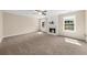 Large living room with plush carpet, a fireplace, and large windows offering ample natural light at 3559 Reservoir Pass, Acworth, GA 30101