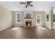 Bright living room features a fireplace, a ceiling fan, and a backyard view at 3559 Reservoir Pass, Acworth, GA 30101
