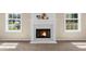 Bright living room featuring a fireplace with white mantel and natural light from the surrounding windows at 3559 Reservoir Pass, Acworth, GA 30101