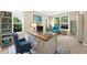 Bright home office featuring built-in bookshelves, a stylish desk, and comfortable seating at 3559 Reservoir Pass, Acworth, GA 30101