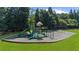 A spacious community playground with varied climbing and sliding options in a green lawn setting at 3559 Reservoir Pass, Acworth, GA 30101