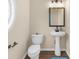 Bright powder room featuring a pedestal sink, modern fixtures, and dark wood-look flooring at 3559 Reservoir Pass, Acworth, GA 30101