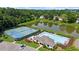 Aerial view showcasing tennis courts, a swimming pool, and a scenic pond in this amenity-rich community at 3559 Reservoir Pass, Acworth, GA 30101