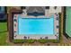 An aerial view of a pristine, large swimming pool with ample lounge seating and surrounding greenery in this neighborhood at 3559 Reservoir Pass, Acworth, GA 30101