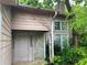Entrance of a home with a stone column and overgrown greenery at 5035 Chadwick Ct, Decatur, GA 30035