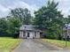 Exterior shot of a home with stone facade and overgrown greenery at 5035 Chadwick Ct, Decatur, GA 30035