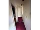 A narrow hallway that leads to a bathroom with a door on the left at 5035 Chadwick Ct, Decatur, GA 30035
