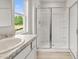 A full bathroom showcasing a granite countertop and walk in shower with glass doors at 504 Oak View Ln, Dallas, GA 30157