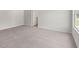 A bedroom with plush gray carpet and a window for natural light at 504 Oak View Ln, Dallas, GA 30157