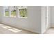 A room featuring light wood flooring, white walls, and large bright windows at 504 Oak View Ln, Dallas, GA 30157