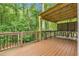 Spacious deck with covered area, wooden railings, and bar seating for outdoor entertaining at 5930 Shannon Drive Dr, Cumming, GA 30040