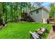 Expansive backyard featuring artificial turf, tiered deck, with stairs to ground, and lounging spaces perfect for relaxation at 5930 Shannon Drive Dr, Cumming, GA 30040