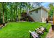 Spacious backyard featuring a multi-level deck, putting green, and ample space for outdoor entertaining at 5930 Shannon Drive Dr, Cumming, GA 30040