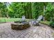 Outdoor seating area featuring a built-in fire pit and comfortable seating, surrounded by landscaping at 5930 Shannon Drive Dr, Cumming, GA 30040