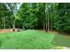 Backyard featuring green turf, putting green, and seating area perfect for outdoor activities at 5930 Shannon Drive Dr, Cumming, GA 30040