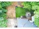 Backyard aerial view featuring an outdoor seating area with a fire pit, a faux-grass area, and mature trees at 5930 Shannon Drive Dr, Cumming, GA 30040