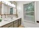 Bathroom vanity area with white countertop and decorative mirror at 5930 Shannon Drive Dr, Cumming, GA 30040