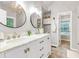 Bright bathroom featuring a double sink vanity with modern fixtures and two decorative round mirrors at 5930 Shannon Drive Dr, Cumming, GA 30040
