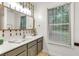 Neutral bathroom featuring a large mirror and views of the outside at 5930 Shannon Drive Dr, Cumming, GA 30040