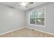 Bedroom features carpet flooring, a ceiling fan, and a bright window at 5930 Shannon Drive Dr, Cumming, GA 30040